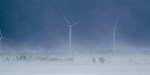wind turbines during the winter season with snow all around